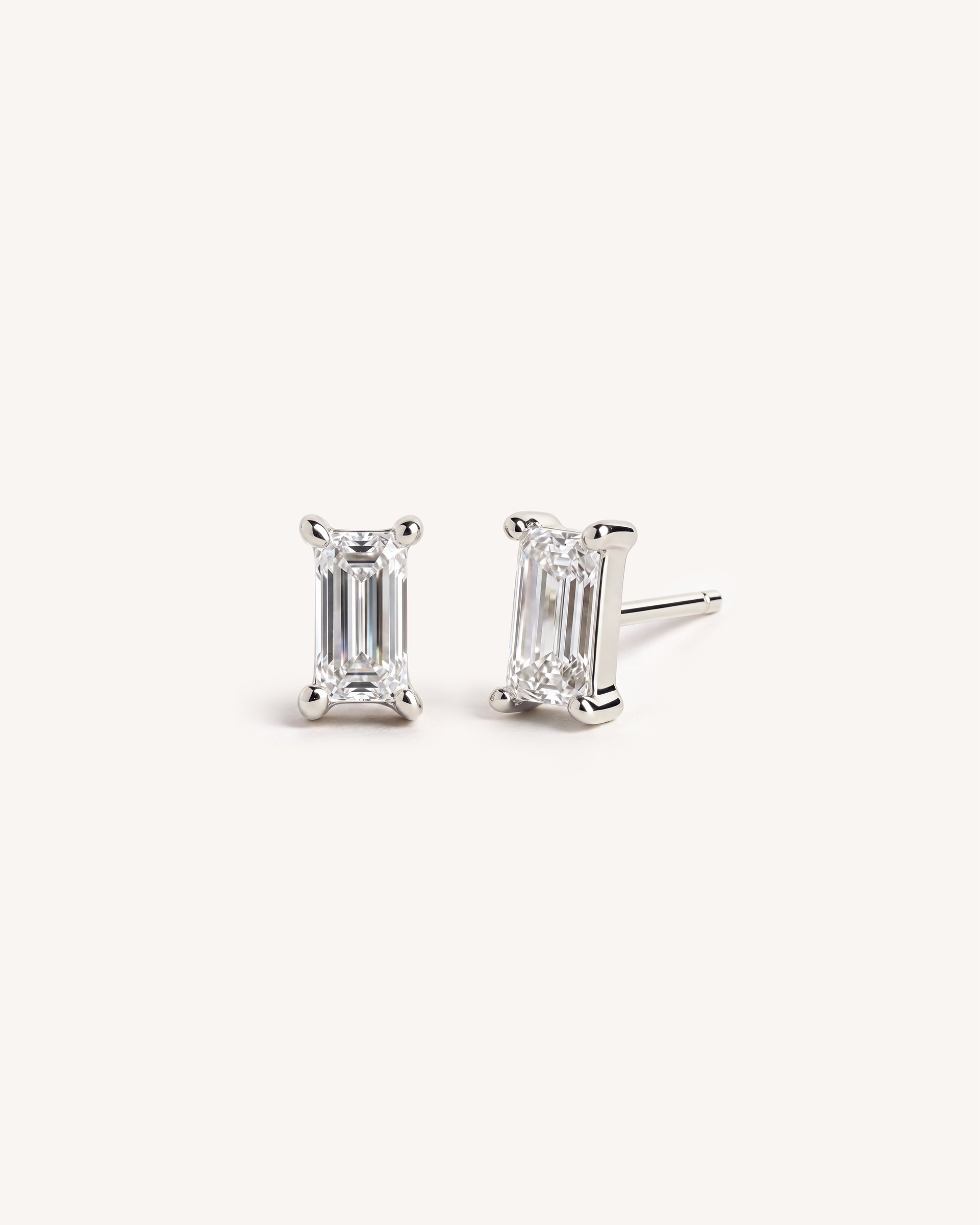 925 Sterling Silver White CZ solitaire baguette stud earrings on a white background.