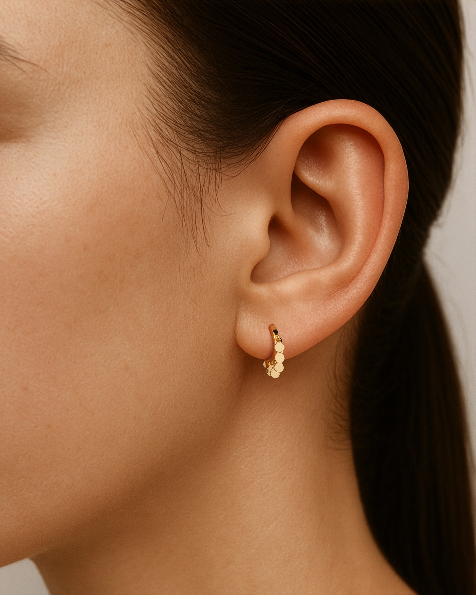 Mini Coin Huggie Hoops in Gold — alternate view