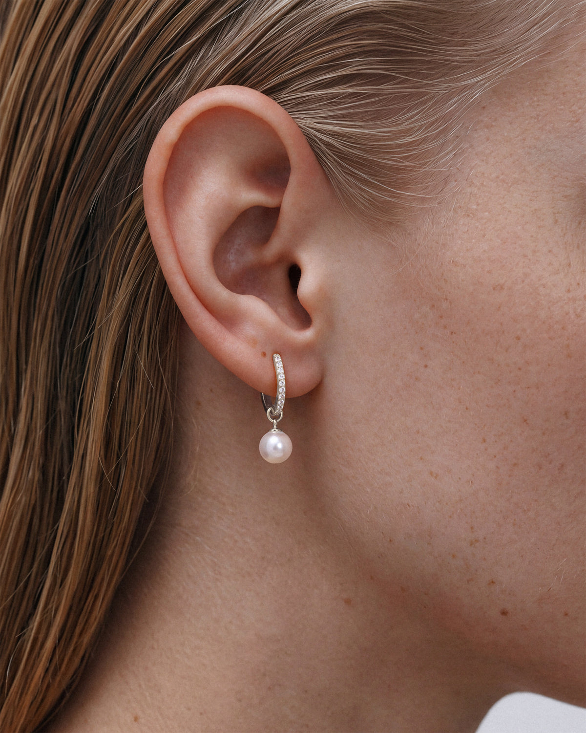 925 sterling silver rhodium plated pavé huggie hoop earring with pearl drop charm, 925 sterling silver, worn on the ear
