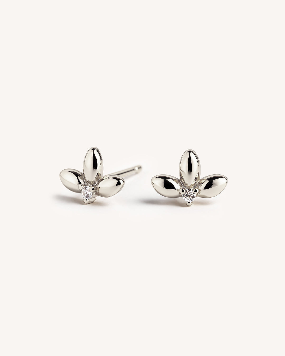 Small 925 sterling silver petal shaped studs with a small cz stone in the center on a white plain background.
