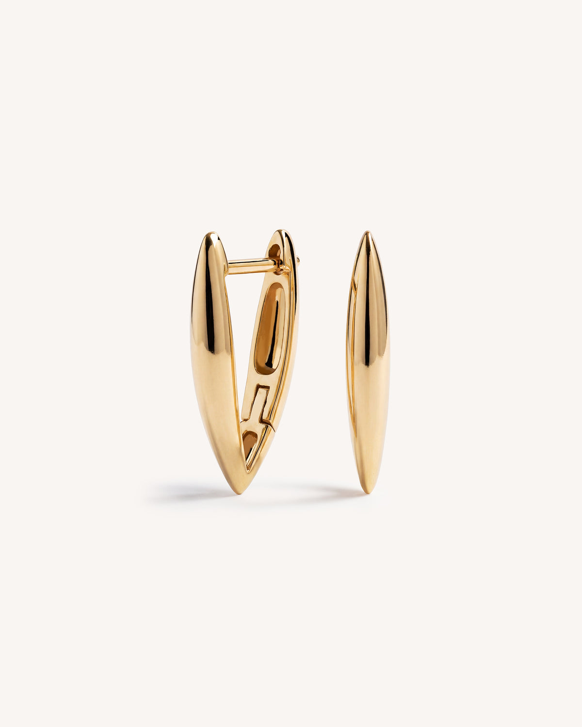 A pair of gold-toned geometric V shaped huggie hoop earrings with a polished finish, displayed on a clean off-white background.