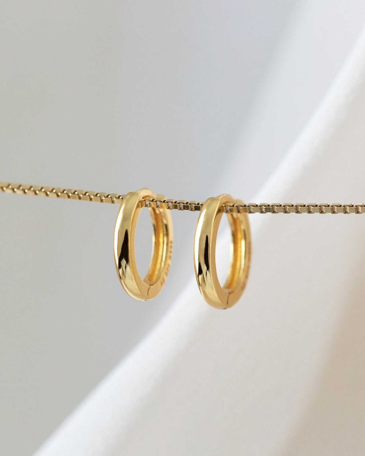 Classic Huggie Hoops in Gold — alternate view - still life