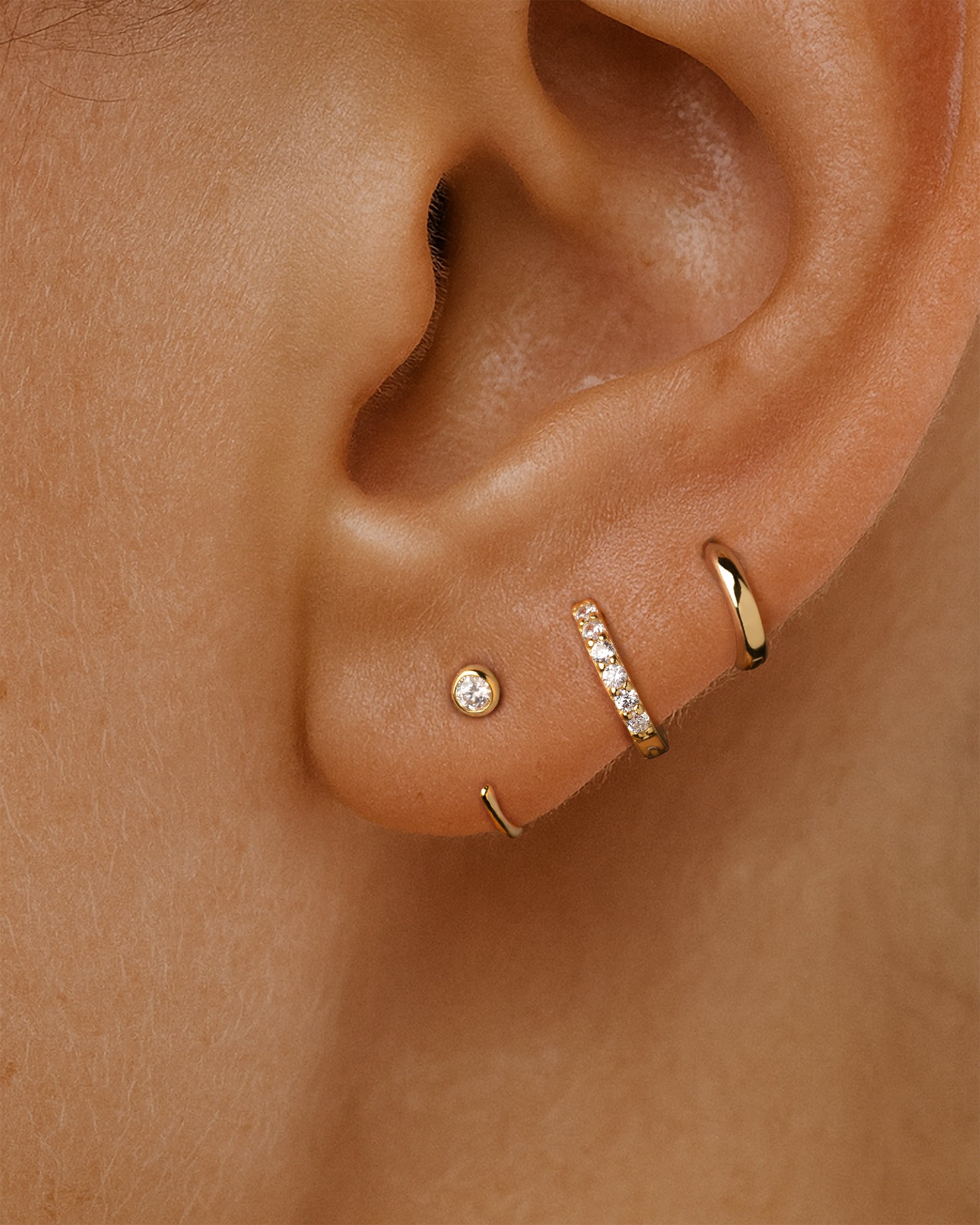 Open Solitaire Huggie Earrings in Gold — alternate view