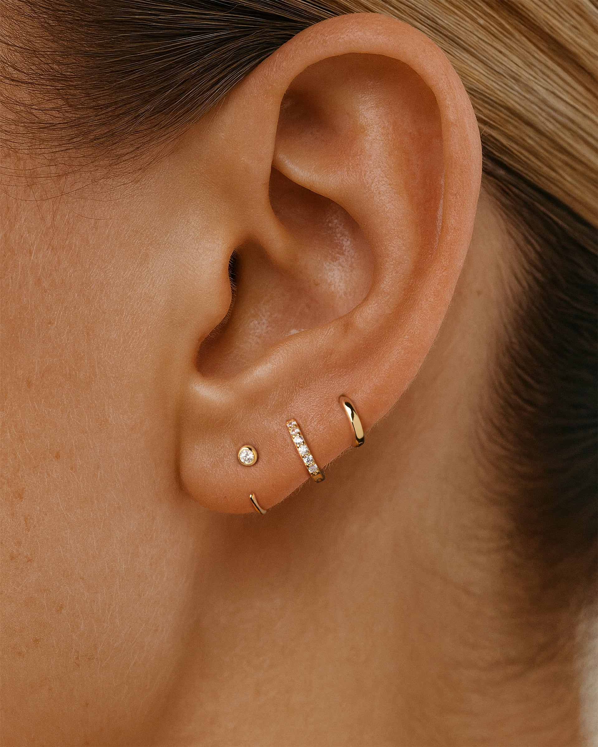 Open Solitaire Huggie Earrings in Gold — alternate view