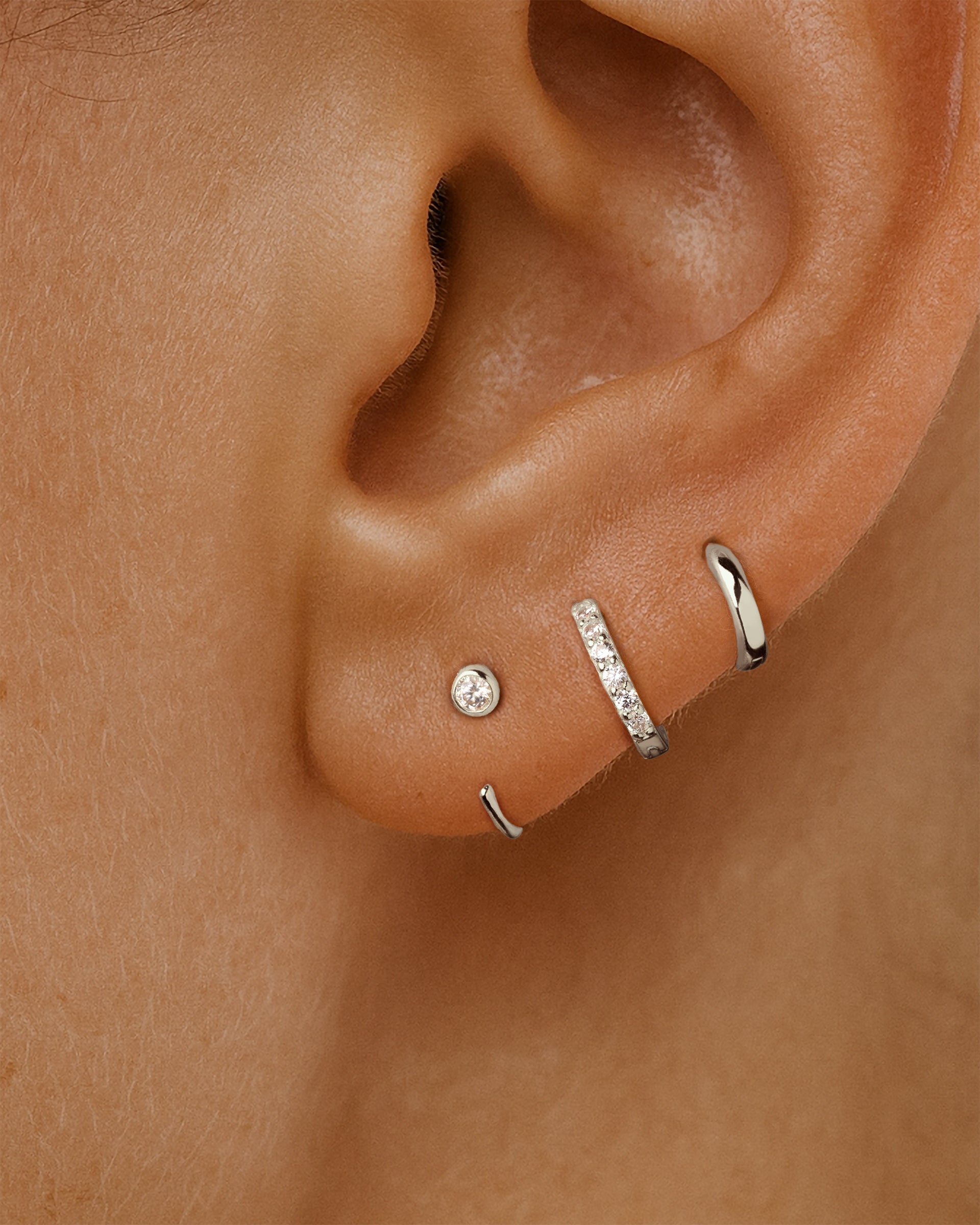 Open Solitaire Huggie Earrings in Silver — alternate view
