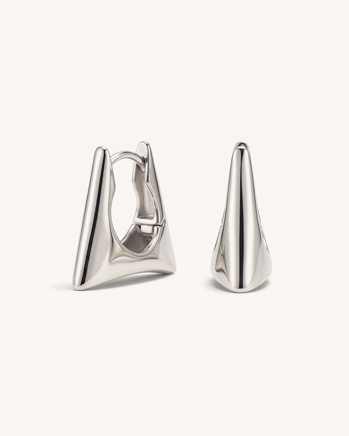 A pair of polished silver geometric hoop earrings with sharp triangular tips, displayed on a clean off-white background.
