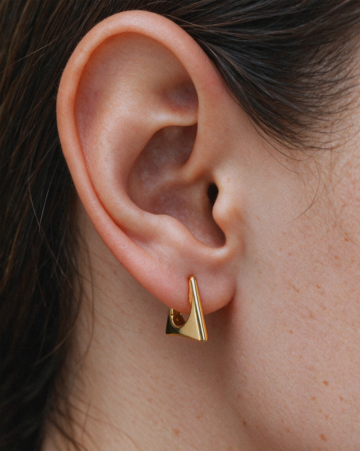 Chunky gold triangle hoop earring, 18k gold-plated sterling silver, on model