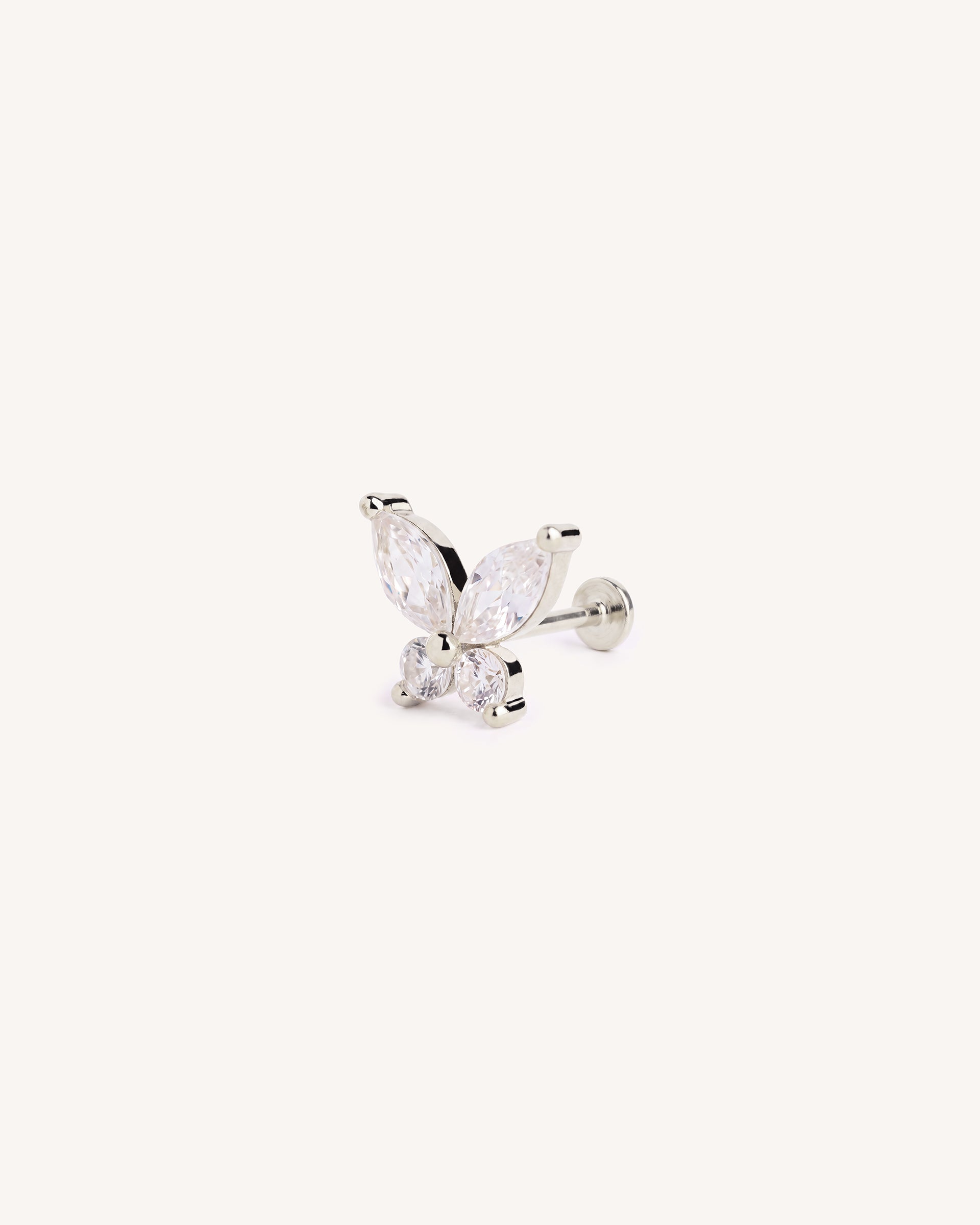 A silver butterfly flatback labret stud earring featuring marquise-cut and round clear gemstones, shown on a plain off-white background.