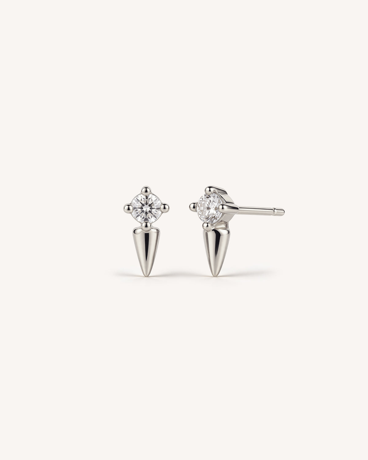 Two 925 sterling silver spike studs with a clear CZ stone on the top against a plain white background.