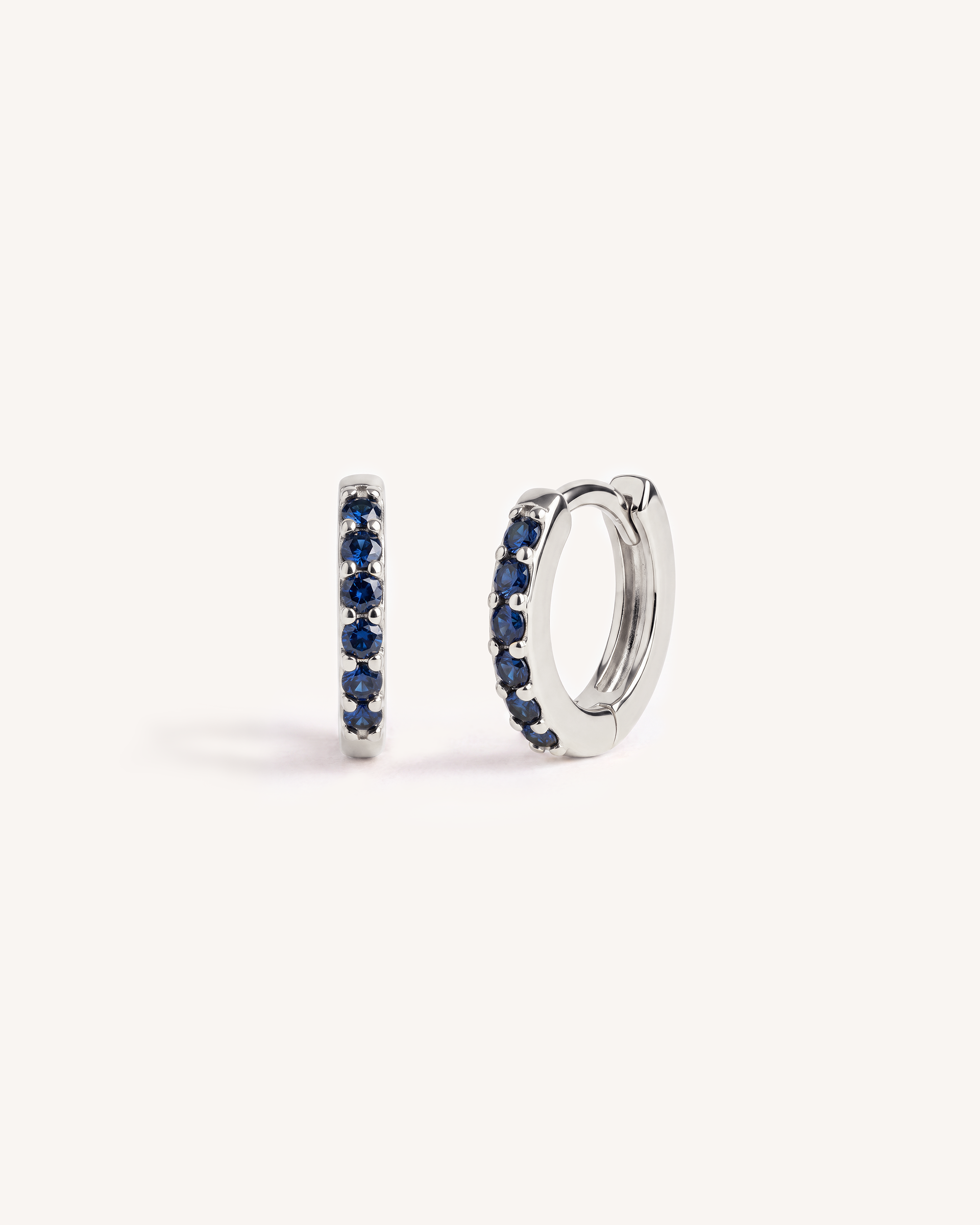 Mini Pave Huggie Hoops in Silver — Sapphire Blue Stone