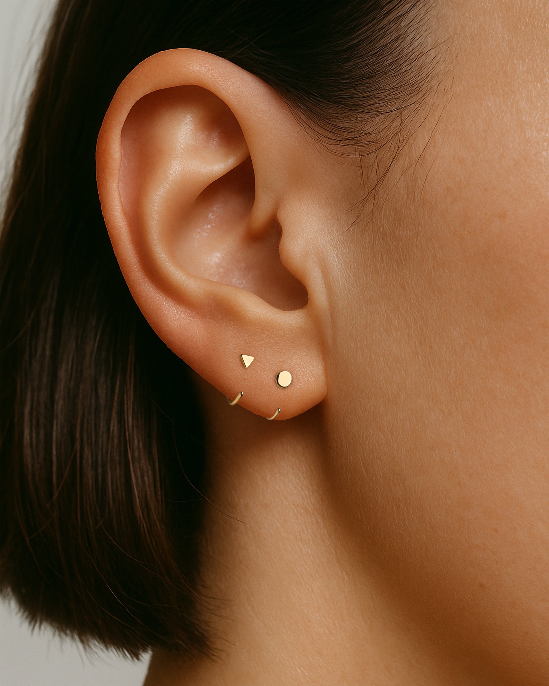 Open Triangle Huggie Earrings in Gold — alternate view