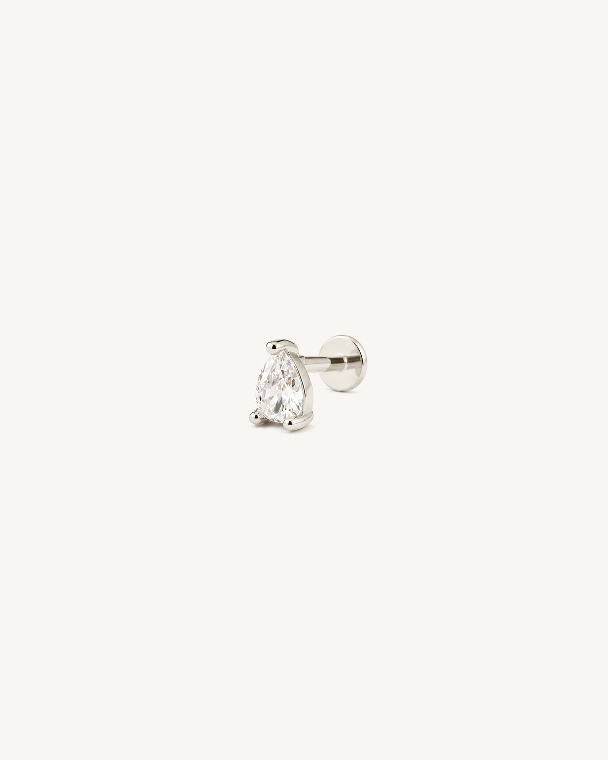 A single 925 sterling silver flatback labret stud earring featuring a pear-cut clear gemstone in a prong setting, shown against a solid off-white background.
