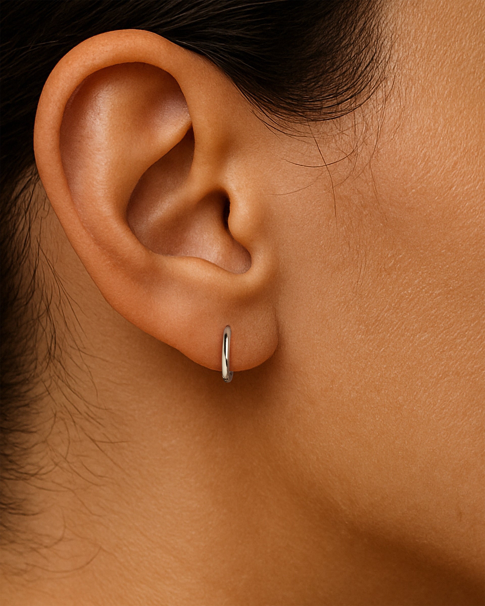 Thin Huggie Hoops in Silver — alternate view