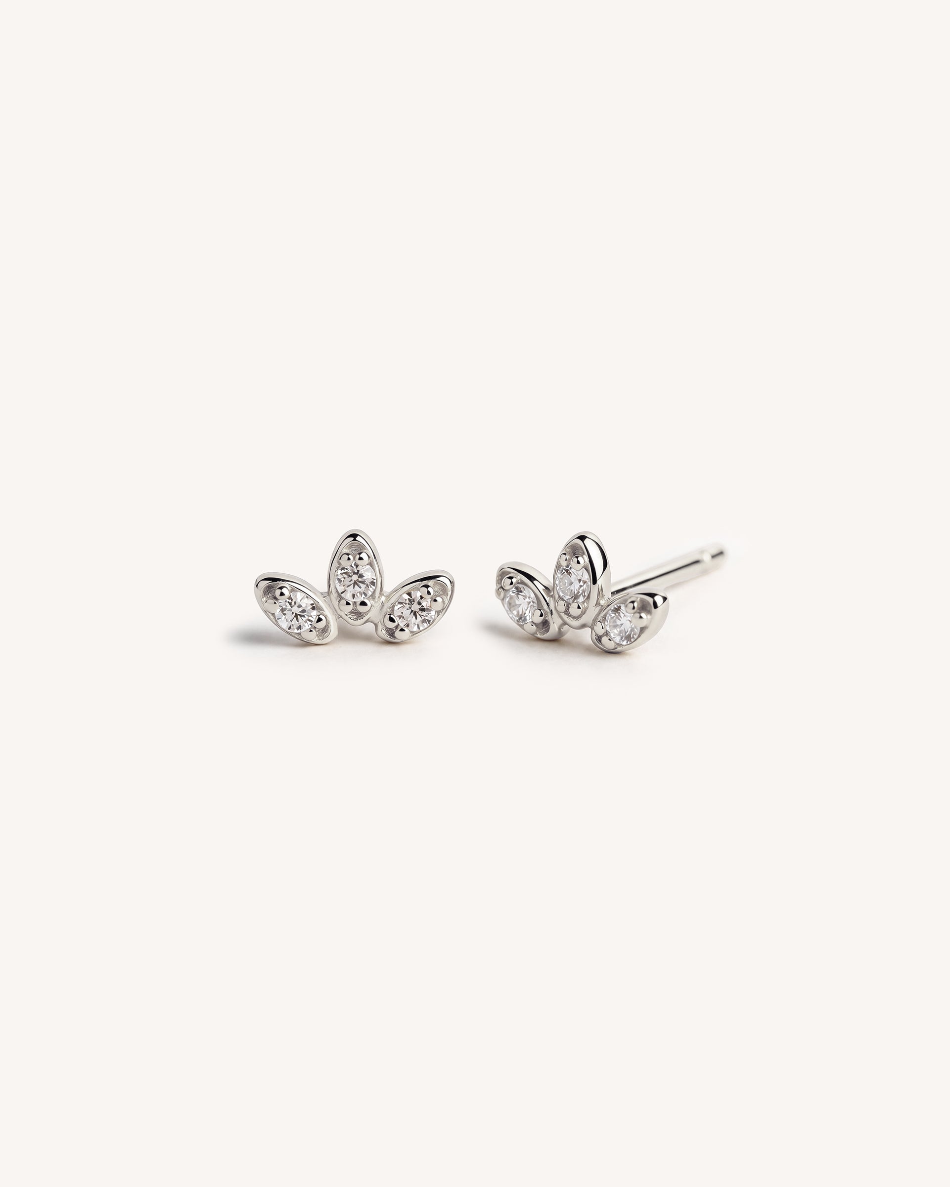 A pair of 925 sterling silver stud earrings with marquise-cut clear gemstones arranged in a small leaf or cluster shape, photographed on a clean off-white background.
