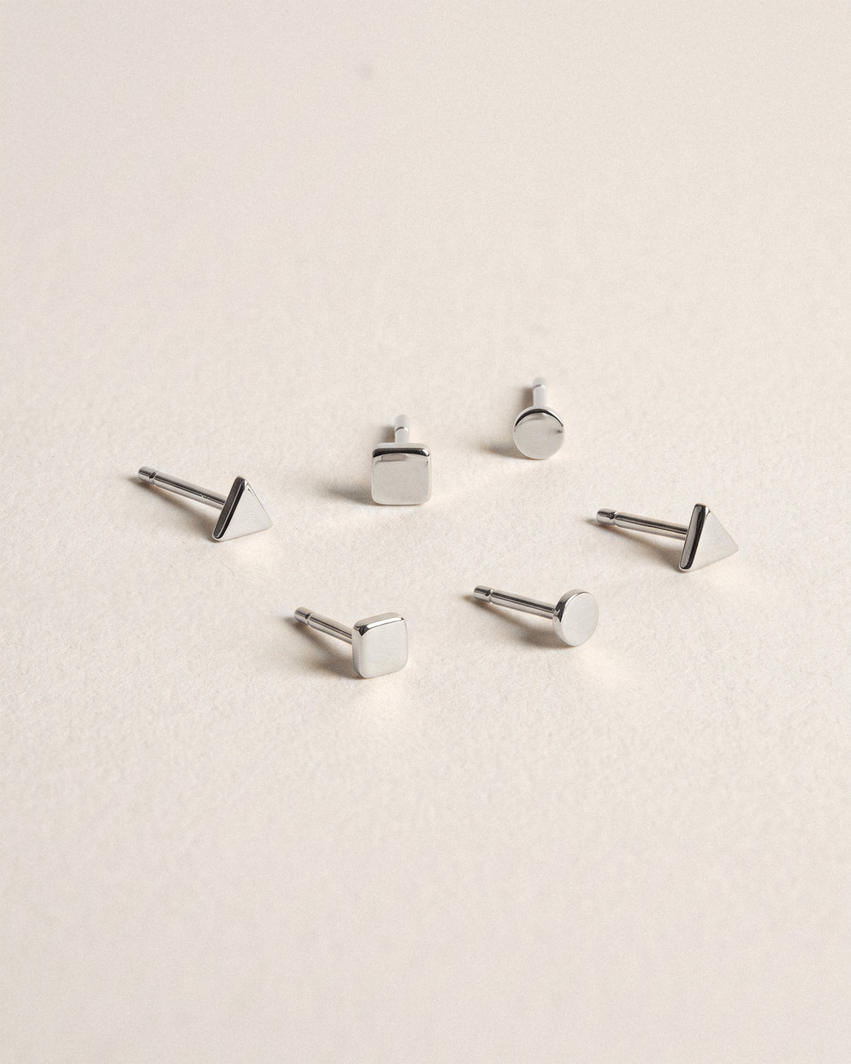 Tiny Triangle Studs, Tiny Dot Studs and Tiny Square Studs in 925 rhodium plated sterling silver