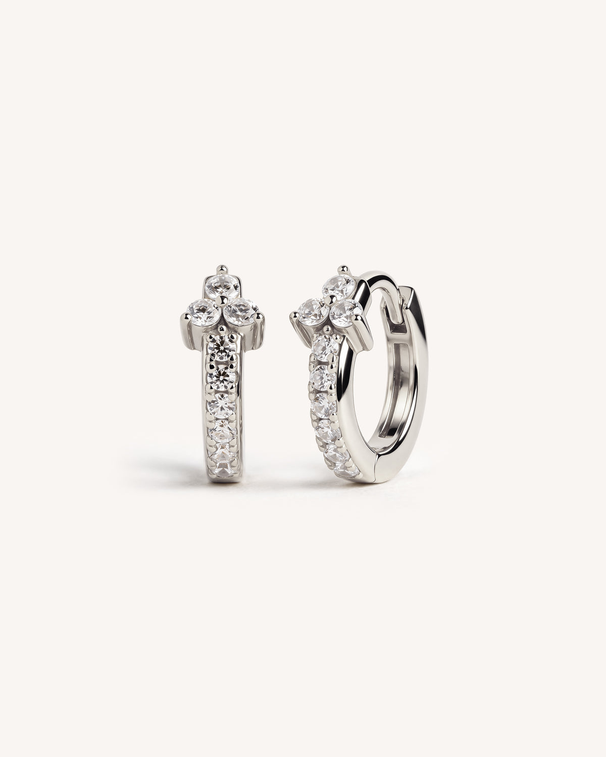 Mini CZ Pave huggie hoops in sterling silver on a plain white background.