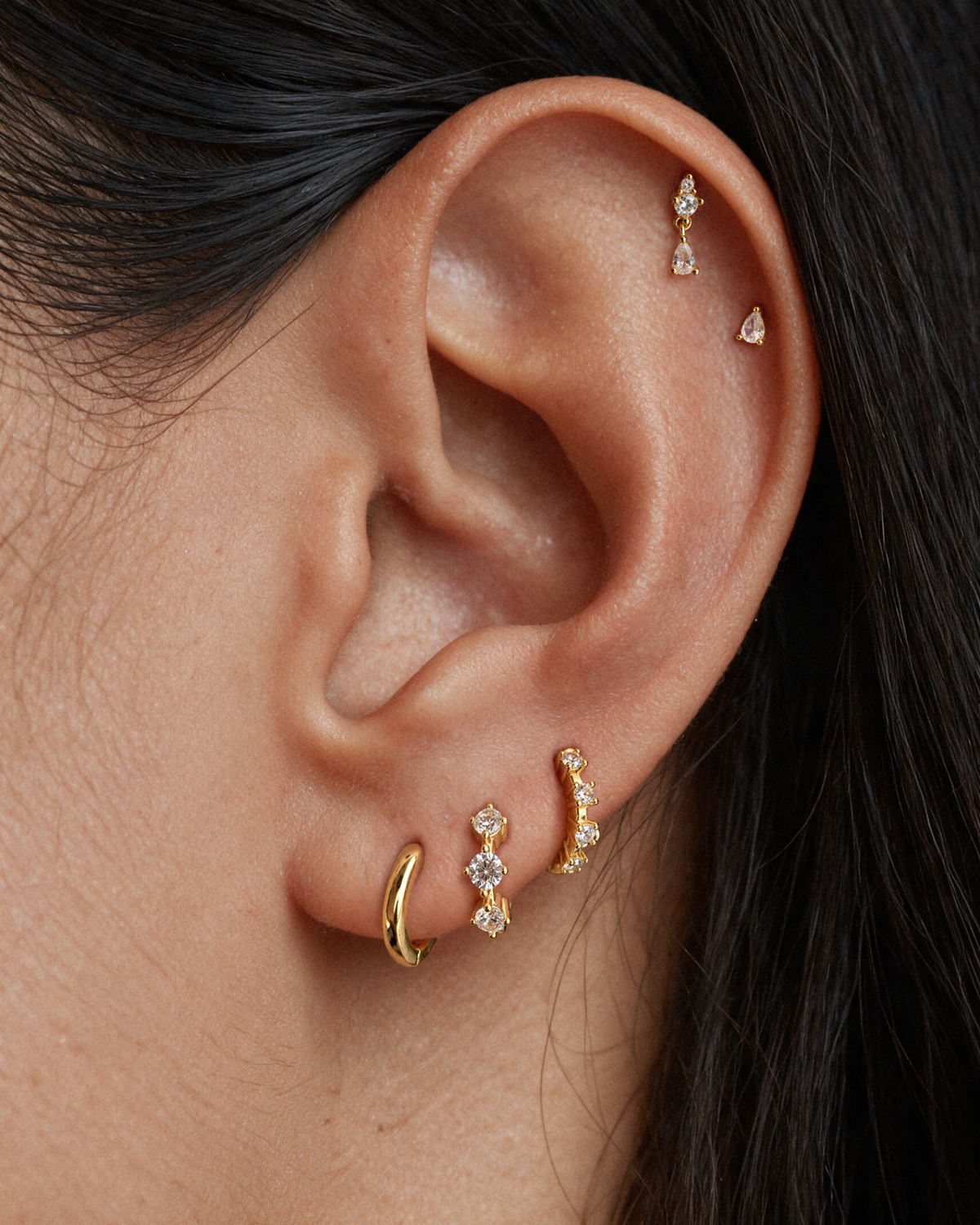The crystal ear stack with five gold and crystal earrings