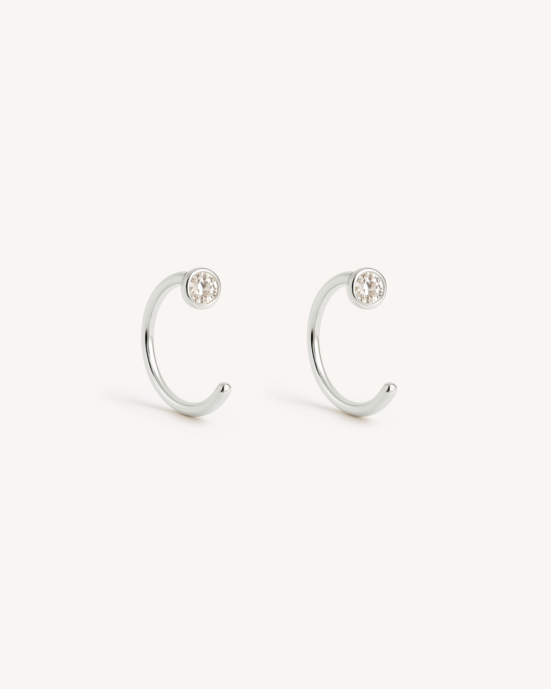 Open Solitaire Huggie Earrings in Silver