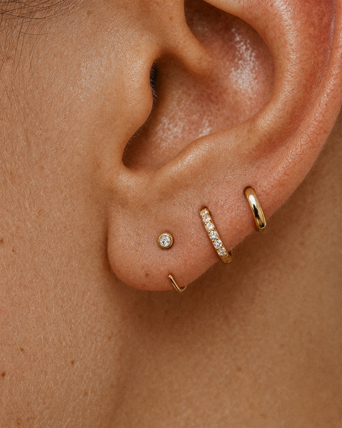 Open Solitaire Huggie Earrings in Gold — alternate view