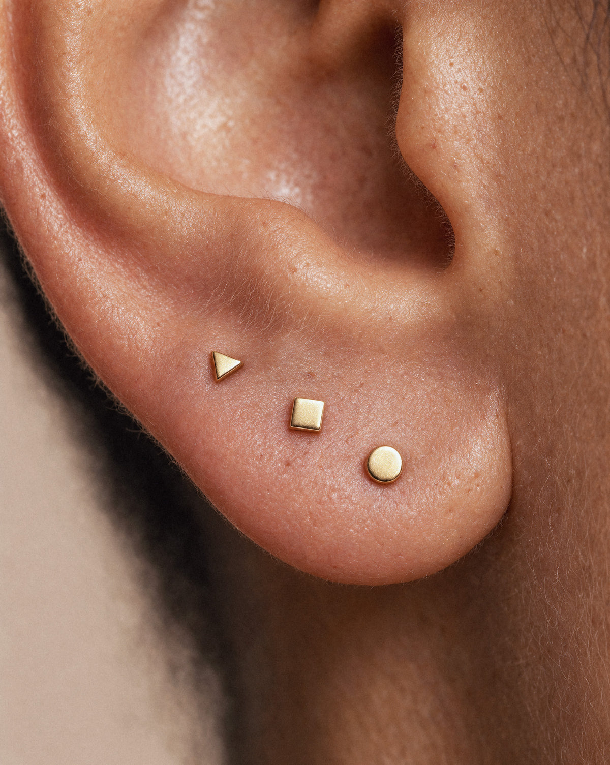 Tiny Triangle Studs in Gold — alternate view close up